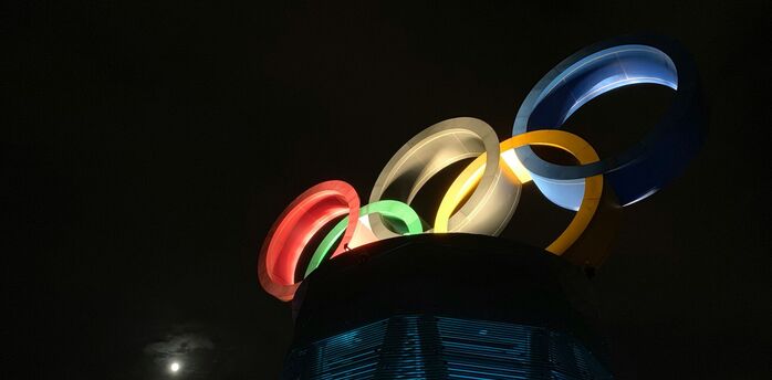 Illuminated Olympic rings installation at night