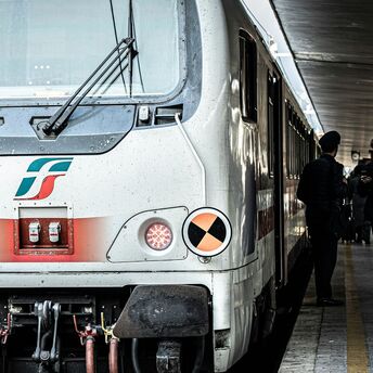 Italian regional trains at a busy station platform