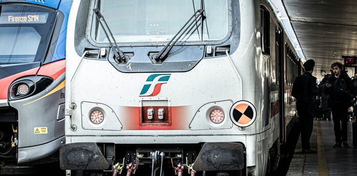 Italian regional trains at a busy station platform