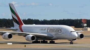 Emirates plane taxiing on the runway at an airport