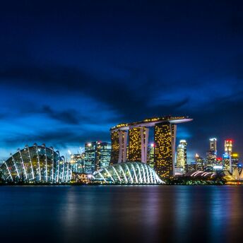Singapore skyline at night featuring Marina Bay Sands and Gardens by the Bay