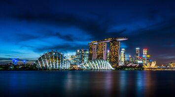 Singapore skyline at night featuring Marina Bay Sands and Gardens by the Bay