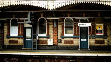 Ipswich railway station platform with historic brick architecture and signage