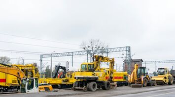 Construction machinery and railway maintenance equipment at a railway site under repair