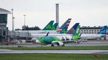 Aer Lingus aircraft taxiing at Dublin Airport with multiple airline tails in the background