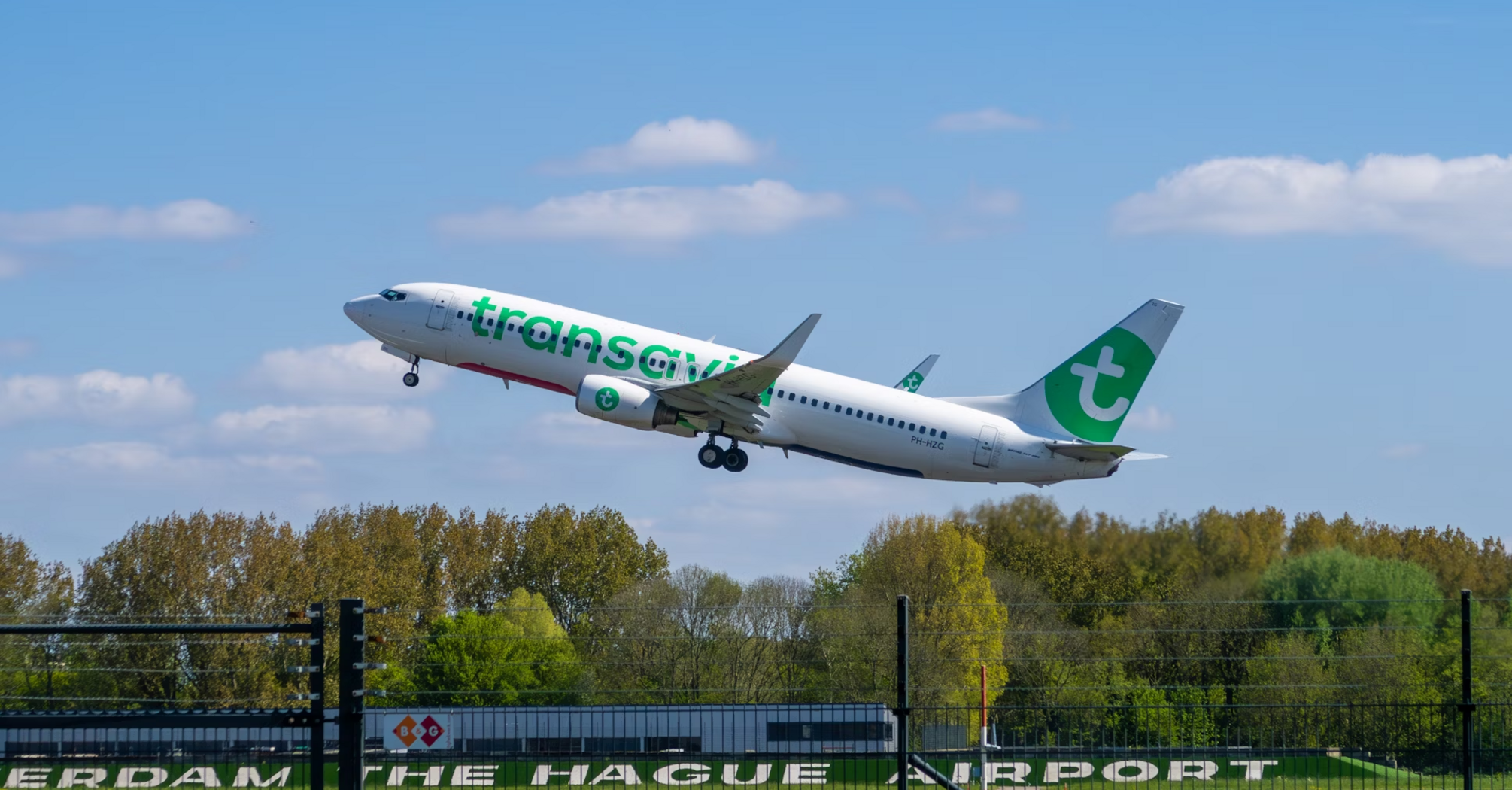 Transavia airplane taking off from Rotterdam The Hague Airport on a clear day