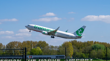 Transavia airplane taking off from Rotterdam The Hague Airport on a clear day