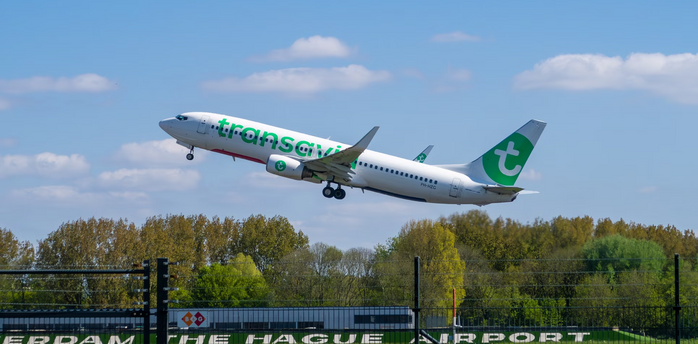 Transavia airplane taking off from Rotterdam The Hague Airport on a clear day