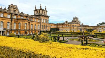 Historic Blenheim Palace with landscaped gardens and ornate fountains in springtime