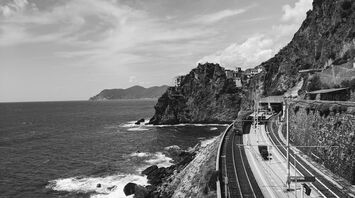 A scenic railway station along the Ligurian coast, surrounded by cliffs and overlooking the Mediterranean Sea