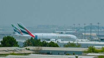 Emirates aircraft parked at Dubai International Airport during daytime