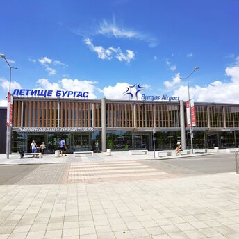 Burgas Airport departures terminal with travelers outside on a sunny day