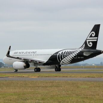 Air New Zealand aircraft on the runway, featuring the airline's black and white fern livery