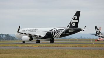 Air New Zealand aircraft on the runway, featuring the airline's black and white fern livery