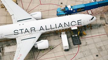 Airplane with Star Alliance livery parked at gate at the airport