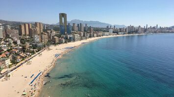 Aerial view of Benidorm’s beachfront and high-rise skyline on a clear summer day