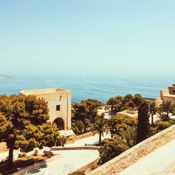 Scenic view of the Andalusian coastline with historic architecture and Mediterranean Sea in the background