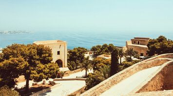 Scenic view of the Andalusian coastline with historic architecture and Mediterranean Sea in the background