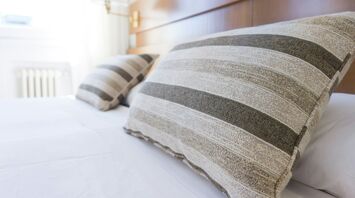 Close-up of pillows on a neatly made hotel bed