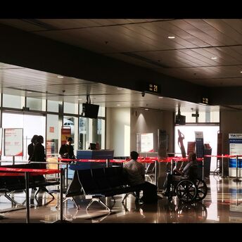 Gate area with seated passengers and mobility aid