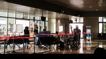 Gate area with seated passengers and mobility aid