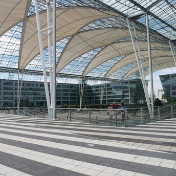 Munich Airport's central plaza with glass roof and modern architecture