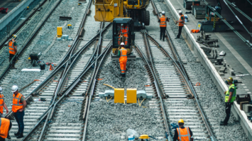 Rail workers conducting track maintenance during daytime engineering works