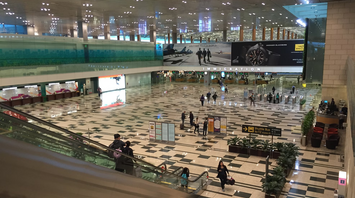 Interior view of Singapore Changi Airport Terminal 2 with immigration area and directional signs