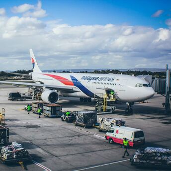 Malaysia Airlines aircraft being loaded at the airport gate