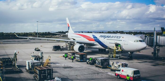 Malaysia Airlines aircraft being loaded at the airport gate