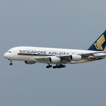 Singapore Airlines Airbus A380 aircraft in mid-flight against a grey sky