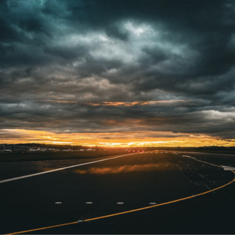 Runway at Edinburgh Airport during dramatic sunset skies
