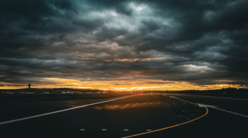 Runway at Edinburgh Airport during dramatic sunset skies