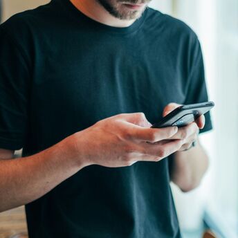 Person using a smartphone to leave a review at a restaurant