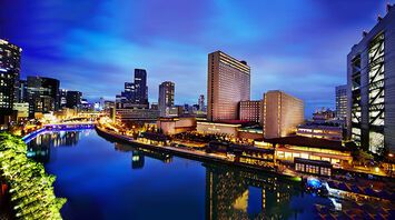 Night view of RIHGA Royal Hotel Osaka along the river in the Nakanoshima district