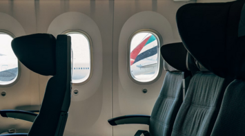 Empty seats with aircraft visible through windows