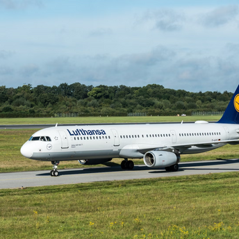 Lufthansa airplane on runway at sunset