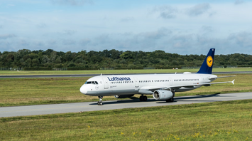 Lufthansa airplane on runway at sunset