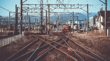 Train tracks stretching through a quiet landscape