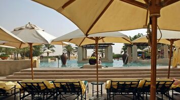 Poolside seating with umbrellas and chairs