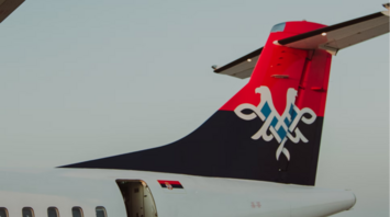 Air Serbia airplane tail with national emblem under clear sky