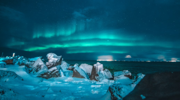 Northern Lights over snowy coastline