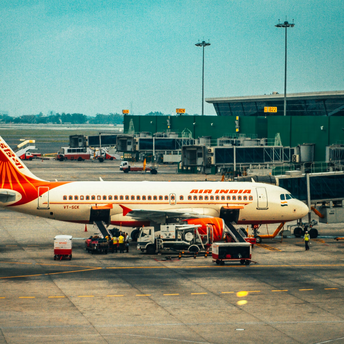 Air India aircraft parked at an airport terminal during ground handling operations