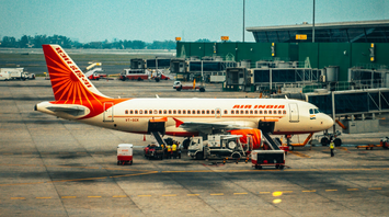 Air India aircraft parked at an airport terminal during ground handling operations