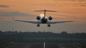 Passenger airplane taking off from runway during sunset