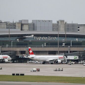 Zurich Airport terminal with Swiss aircraft on the tarmac