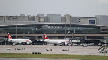 Zurich Airport terminal with Swiss aircraft on the tarmac