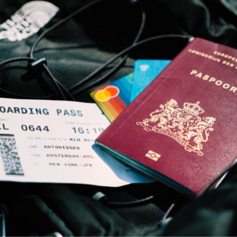 Passport, boarding pass, and credit cards on a backpack