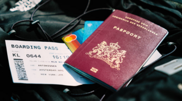 Passport, boarding pass, and credit cards on a backpack