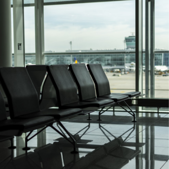 Empty Munich Airport seating area with view of tarmac and terminal windows